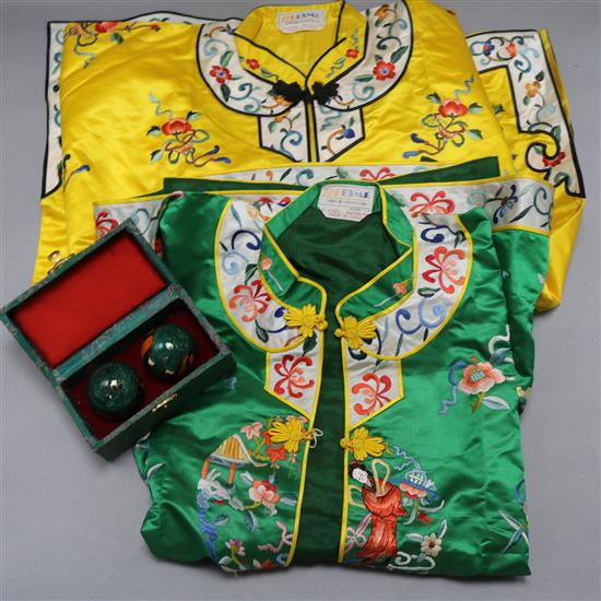 Two Chinese silk embroidered jackets with two Chinese musical enamelled balls, cased